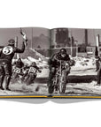 Assouline The Race of Gentlemen coffee table book displaying a man in a motorcycle race on a white back ground available at Spacio India for luxury home decor accessories collection of Sports Coffee Table Books.