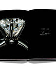Assouline Tiffany Co Vision and Virtuosity Icon Edition coffee table book displaying a Diamond Ring on a white back ground available at Spacio India for luxury home decor accessories collection of Jewellery Coffee Table Books.