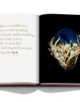 Assouline Cipullo: Making Jewelry Modern coffee table book displaying photo of Blue Lapis Lazuli & Diamonds Ring on a coffee table available at Spacio India for luxury home decor collection of Jewellery Coffee Table Books.