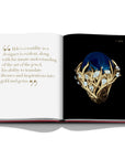 Assouline Cipullo: Making Jewelry Modern coffee table book displaying photo of Blue Lapis Lazuli & Diamonds Ring on a coffee table available at Spacio India for luxury home decor collection of Jewellery Coffee Table Books.