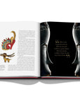 Assouline Cipullo: Making Jewelry Modern coffee table book displaying photo Two Masks' side angles with quote & Animal design Jewellery on a coffee table available at Spacio India for luxury home decor collection of Jewellery Coffee Table Books.