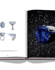 Assouline G Glenn: Spiro the art of a jewel coffee table book displaying photo of sapphire & diamonds ring with sketches on a white back ground available at Spacio India for luxury home decor collection of Jewellery Coffee Table Books.