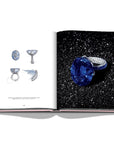 Assouline G Glenn: Spiro the art of a jewel coffee table book displaying photo of sapphire & diamonds ring with sketches on a white back ground available at Spacio India for luxury home decor collection of Jewellery Coffee Table Books.