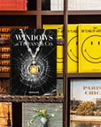 Assouline Windows at Tiffany & Co Icon Edition coffee table book placed on Ladder having book shelf behind available at Spacio India for luxury home decor accessories collection of Jewellery Coffee Table Books.
