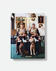 A hardcover book titled 'London Chic' by Charles Foster Assouline, featuring a cover photograph of two men in military dress uniforms sitting in a London cab with dogs, shown against a light gray background.