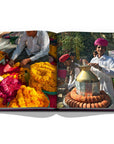 Assouline Jaipur Splendor coffee table book displaying photo of Kulhad Tea Seller & Marigold flowers at Jaipur on a white back ground available at Spacio India for luxury home decor accessories collection of Travel Coffee Table Books.