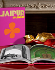 Assouline Jaipur Splendor coffee table book on a coffe table with other book & Bowl available at Spacio India for luxury home decor accessories collection of Travel Coffee Table Books.