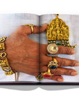 Assouline Jaipur Splendor coffee table book displaying photo of Rajasthani royal man wearing gold jewelleries as a symbol of culture on a white back ground available at Spacio India for luxury home decor accessories collection of Travel Coffee Table Books.