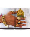 Assouline Jaipur Splendor coffee table book displaying photo of Rajasthani royal man wearing gold jewelleries as a symbol of culture on a white back ground available at Spacio India for luxury home decor accessories collection of Travel Coffee Table Books.