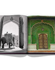 Assouline Jaipur Splendor coffee table book displaying photo of The City palace Green door & Elephants at the gates of Amber Palace, on the outskirts of Jaipur, 1940 on a white back ground available at Spacio India for luxury home decor accessories collection of Travel Coffee Table Books.