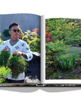 Assouline Tokyo Chic coffee table book page displaying an image of Tradman’s Bonsai founder Teppei Kojima in his garden on a white back ground available at Spacio India for luxury home decor accessories collection of Travel Coffee Table Books.
