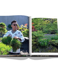 Assouline Tokyo Chic coffee table book page displaying an image of Tradman’s Bonsai founder Teppei Kojima in his garden on a white back ground available at Spacio India for luxury home decor accessories collection of Travel Coffee Table Books.
