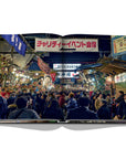 Assouline Tokyo Chic coffee table book page displaying an image of Japanese fair attended by local people on a white back ground available at Spacio India for luxury home decor accessories collection of Travel Coffee Table Books.