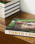 Assouline Tokyo Chic coffee table book on a console table with other Chic Series Books available at Spacio India for luxury home decor accessories collection of Travel Coffee Table Books.