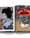 Assouline Tokyo Chic coffee table book page displaying Photo of Japanese lady applying makeup on a white back ground available at Spacio India for luxury home decor accessories collection of Travel Coffee Table Books.