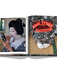 Assouline Tokyo Chic coffee table book page displaying Photo of Japanese lady applying makeup on a white back ground available at Spacio India for luxury home decor accessories collection of Travel Coffee Table Books.