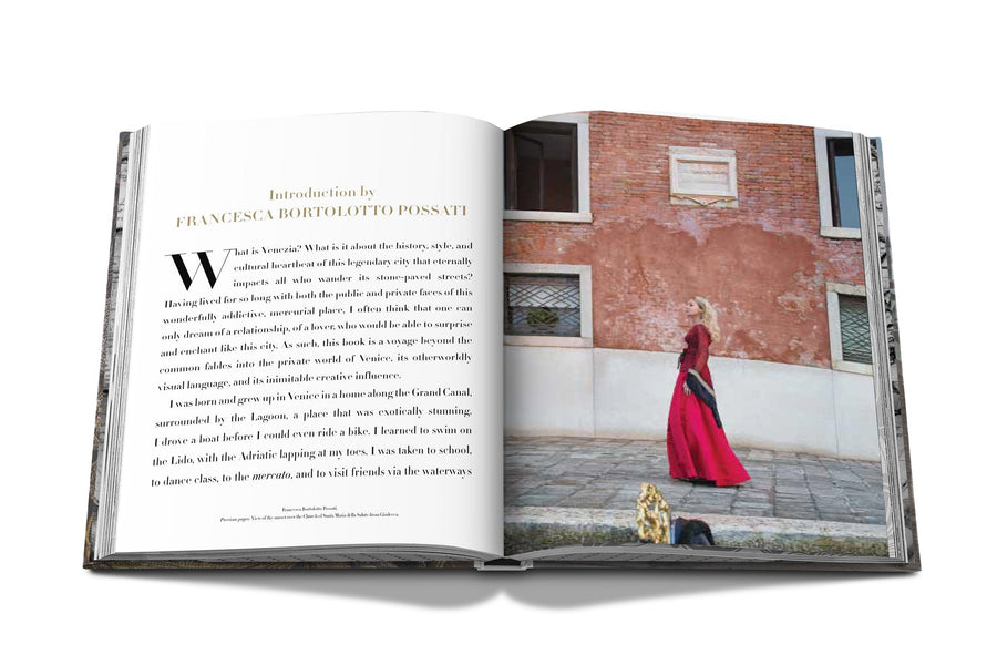 Assouline Venetian Chic coffee table book page picturing a lady at a place of venice city on a white back ground available at Spacio India for luxury home decor accessories collection of Travel Coffee Table Books.