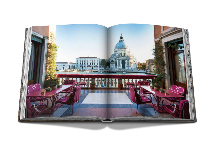 Assouline Venetian Chic coffee table book page picturing balcony restaurant view of Venice on a white back ground available at Spacio India for luxury home decor accessories collection of Travel Coffee Table Books.