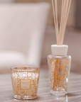 Baobab My First Baobab candle & diffuser from Aurum Gift Set on a wood table available at Spacio India for luxury home decor collection of Gift Sets of Candles & Fragrance.