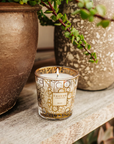 Baobab My First Baobab Aurum candle from Gift Set beside book & vase in modern interior available at Spacio India for luxury home decor collection of Gift Sets of Candles & Fragrance.