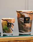 Elegant Baobab Delta Okavango scented candles with hand-blown glass and aromatic fragrance of bergamot, absinthe, and patchouli, displayed in a luxury interior.