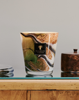 Close-up of Baobab Delta Okavango Candle Max 16, showcasing its unique swirling glass design and warm glow, available at Spacio India.