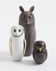 Three Bosa Barns The Owls, including a Barn Owl sculpture, sitting next to each other on a white surface.