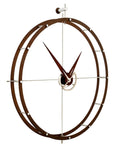 A Nomon clock with a circular design on a white background made of chromed steel.