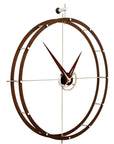 A Nomon clock with a circular design on a white background made of chromed steel.