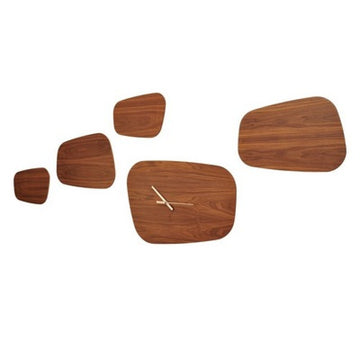 Four exquisite Nomon Isola 5 Walnut (Limited Edition) Wall Clocks, meticulously crafted from solid walnut wood, gracefully hang on a pristine white wall.