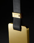 An Esperia Eredania Horizontal luggage tag hanging on a decorative black background.
