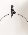 A Gardeco Limited Edition Gardeco Bronze Sculpture Lost in Thoughts, created using the lost wax method, of a monkey sitting on a hoop.