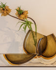 An elegant Gardeco Cance 160 Fume Amber with flowers in it.