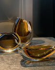 A group of elegant Gardeco Cance 160 Fume Amber on a table, including a and Fume Amber candles.