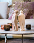 A Gardeco coffee table with two Gardeco Ceramic Sculpture Visitor Plus Beige Cor46 figurines on it, featuring a beige finish.