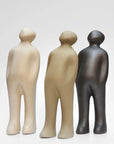 A group of Gardeco Ceramic Sculpture Visitor Plus Sand Cor02 sculptures standing next to each other on a white surface.