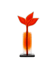 A modern sculpture with a rectangular body, a textured orange-red stem, and three stylized leaf-like forms at the top, resting on a small black base against a white background.