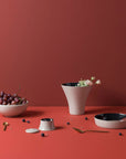 Ibride Ming Lin Muse seven pieces stackable set on a red table surface with other food ingredients available at Spacio India for luxury home decor of collection Tableware Accessories