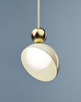 A versatile and vibrant lighting design from the Aurora Collection by Italamp featuring brushed gold accents, white glass diffuser, and retro-inspired finishes. A closeup view of the ivory finish pendant lamp in smaller size