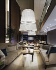 A living room with couches illuminated by a magnificent Italamp Crowns Chandelier from the Italamp Collection.
