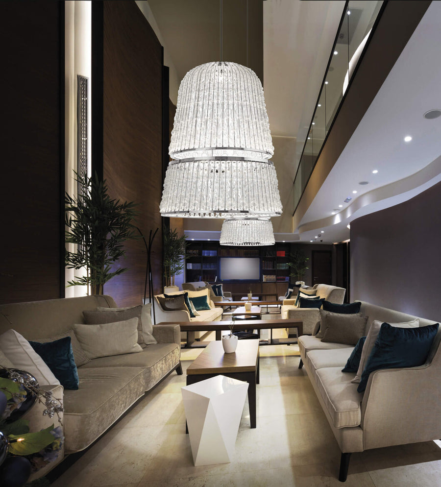 A living room with couches illuminated by a magnificent Italamp Crowns Chandelier from the Italamp Collection.