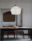 The Italamp Crowns Chandelier, crafted in Italy, features an Imperial Elegance dining room with a chandelier hanging over a table. This stunning piece from Italamp is designed to Illuminate the entire space, creating a luxurious atmosphere.