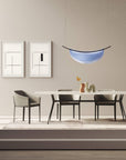 A modern dining room with Italamp Dali chairs, a table, and an Italamp pendant light.