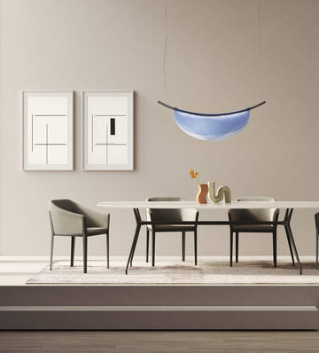A modern dining room with Italamp Dali chairs, a table, and an Italamp pendant light.