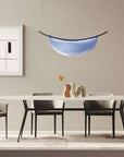A modern dining room with an Italamp Dali pendant light and an Italamp table with chairs.