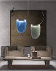 Two Italamp Dali thermoformed glass pendant lights, including an Italamp Dali chandelier, adorning a living room.