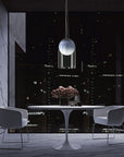 A Italamp Muna table and chairs in a room with a pendant lighting.