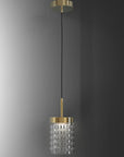 Pendant light with gold fixture and clear glass shade on a gray background from Italamp available at Spacio in India.