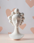 Jonathan Adler Camille Bust Sculpture against a pastel heart-patterned backdrop, perfect decorative porcelain piece available at Spacio India online and retail stores.