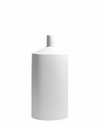 A minimalist white ceramic vase with a cylindrical body and a short, tapered neck, shown against a solid white background.